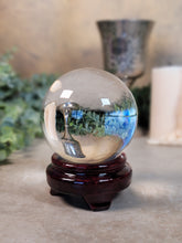 Load image into Gallery viewer, Quartz Crystal Ball with Wooden Stand - Treasures of The Moon
